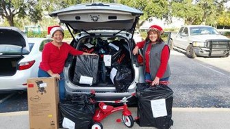 Karen McElveen and Terry Gardner with a truckload of toys for Guardians for New Futures Kids